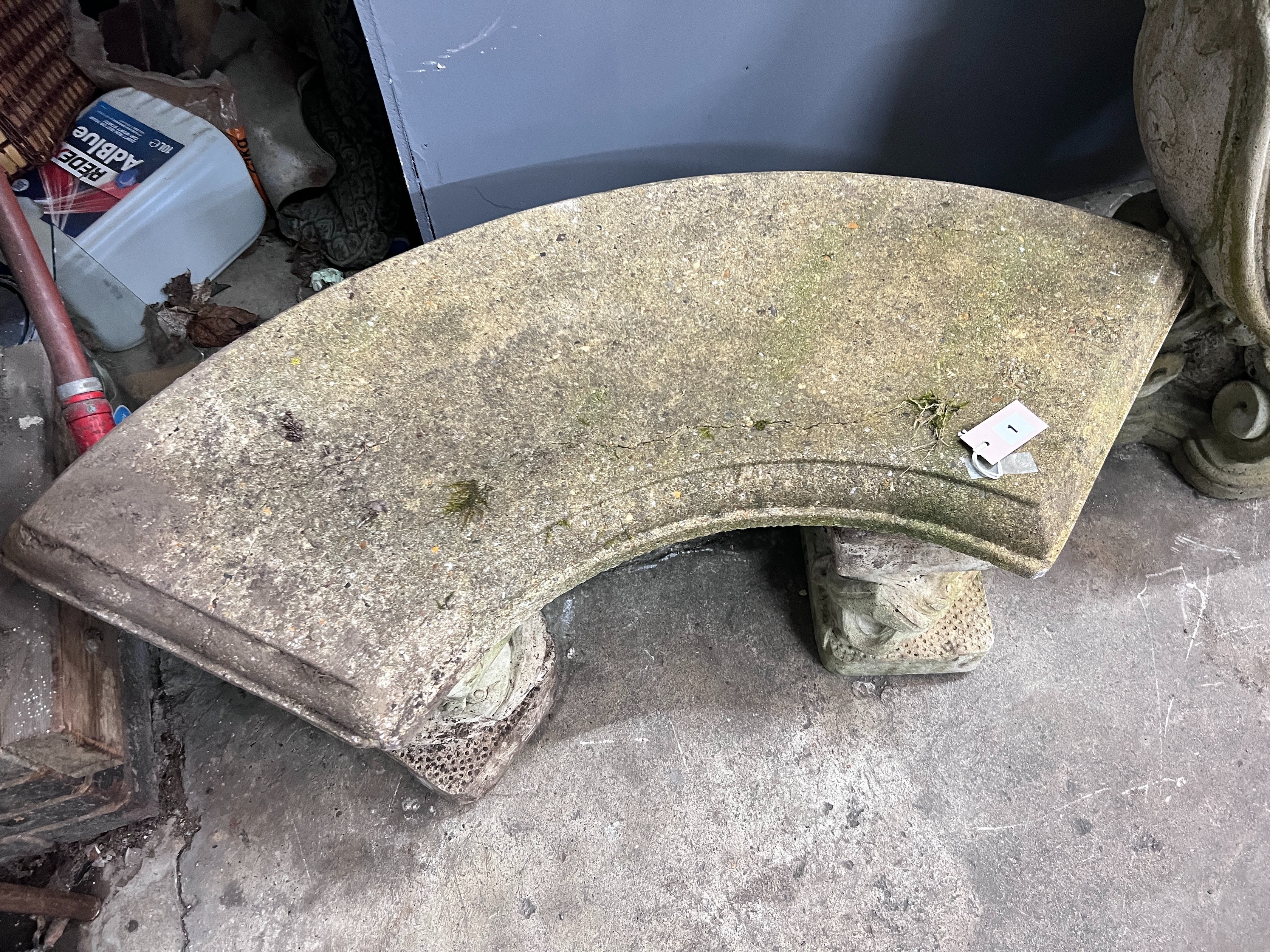 A reconstituted stone curved garden bench with dolphin supports, length 98cm, depth 46cm, height 43cm *Please note the sale commences at 9am.
